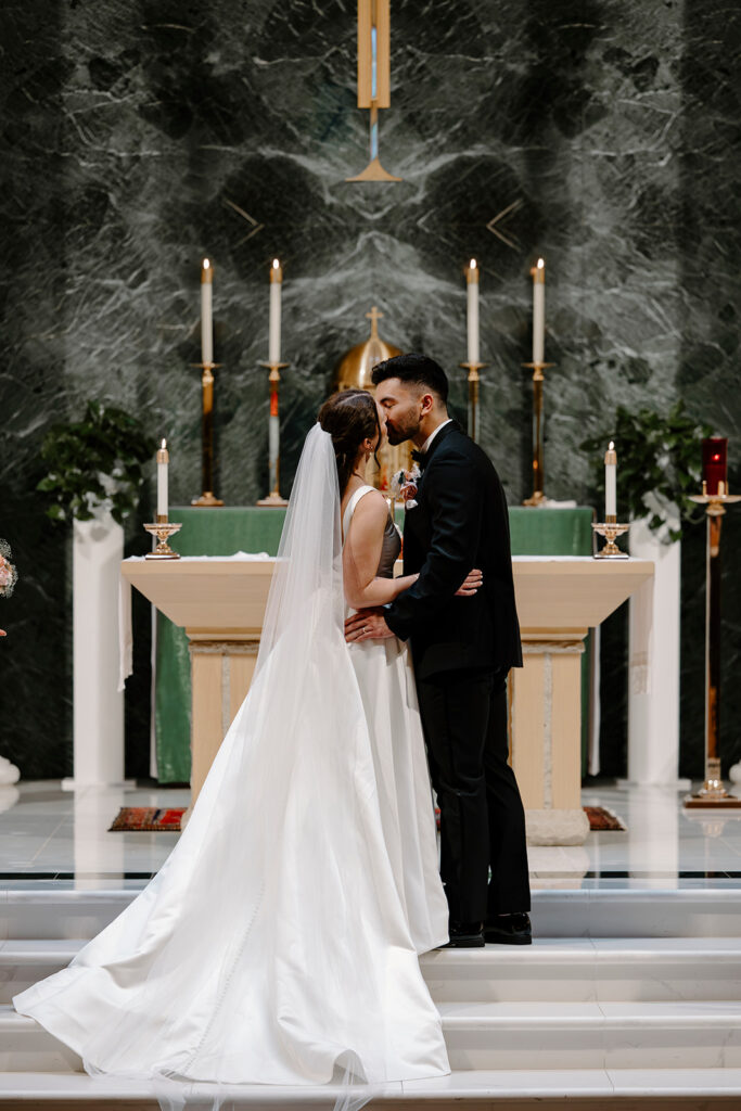 bride and groom kiss at the altar after praise & worship