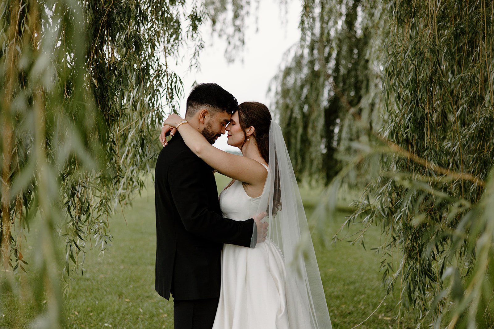 bride and groom in greenery