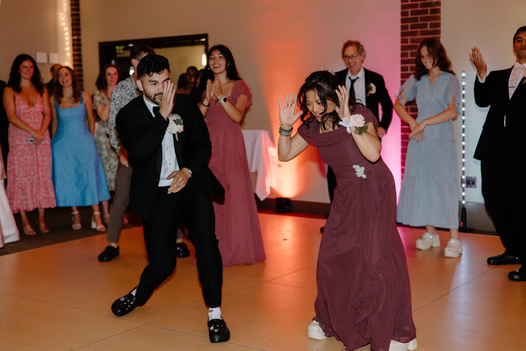 groom and mom praise the Lord by dancing at the reception