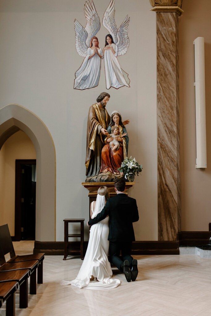 FOCUS Catholic missionaries praying in front of the Holy Family