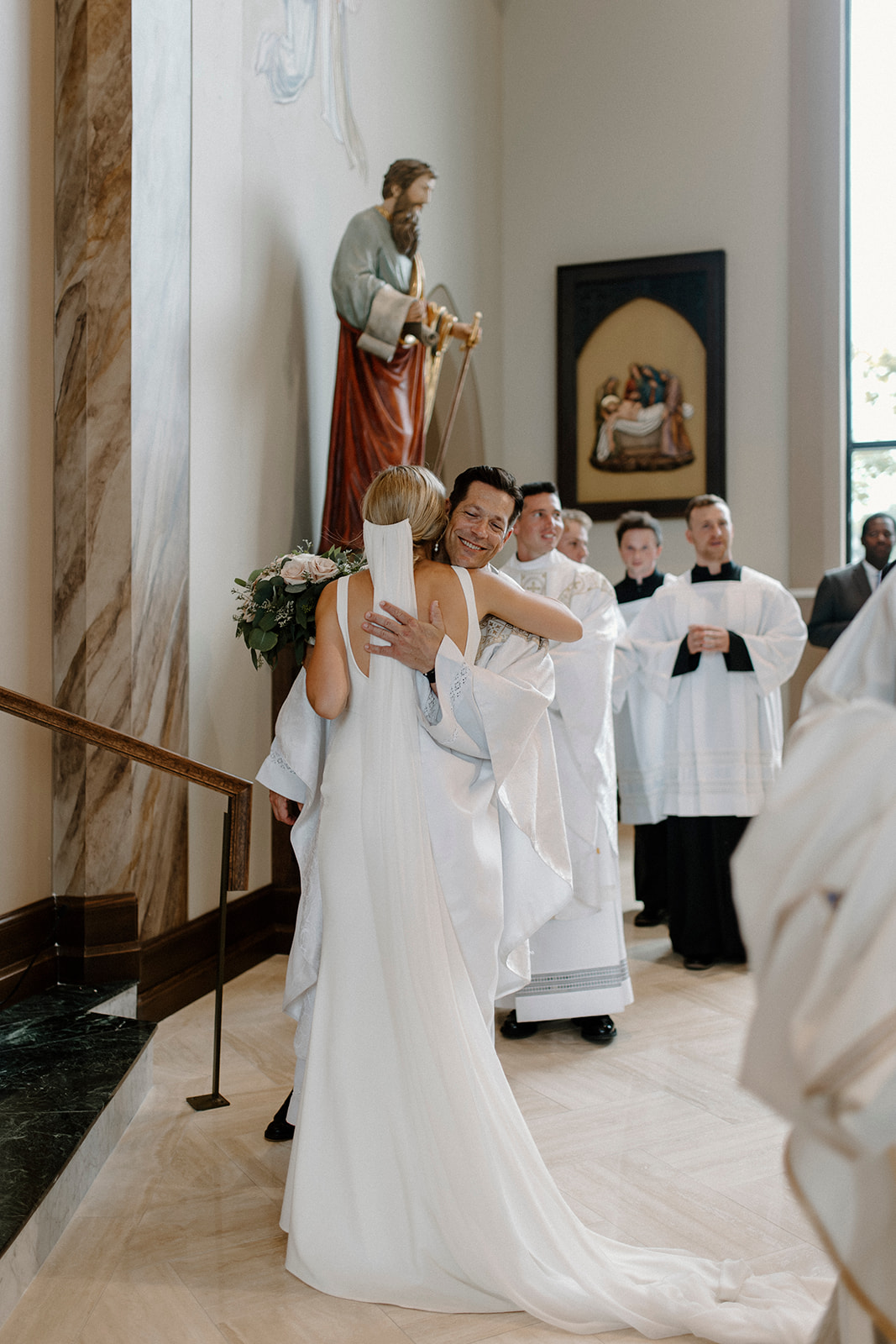 Fr. Mike Schmidtz hugs FOCUS Catholic bride